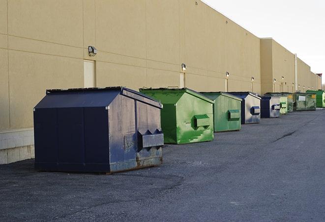 a row of construction dumpsters parked on a jobsite in Alex, OK