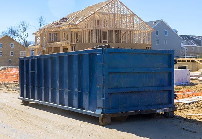 an open-top residential dumpster filled with renovation waste